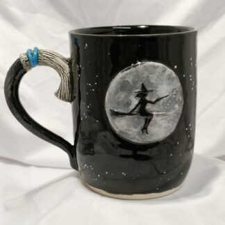 Hand thrown feature Mug. Witch on broom/broom handle